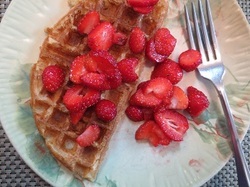 waffle with strawberries on a green plate