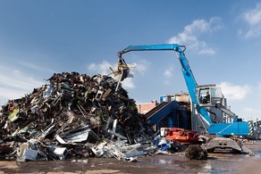 Trencher piling up junk at the dump