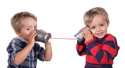 Little boys talking on a tin can phone