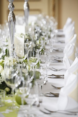 Table set with silver, crystal goblets, and linen