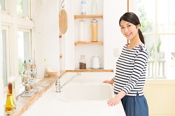 cheerful woman at a clean white counter