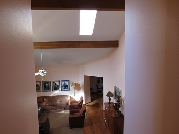 View down stairs to vaulted living room
