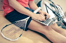 tennis player working on a laptop