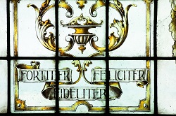 Stained glass window reading fortiter, feliciter, fideliter