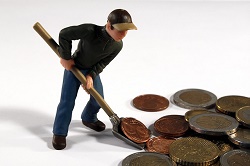 toy man shoveling up money