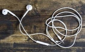 White earbuds with cord coiled up