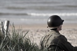 Soldier looking across a beach