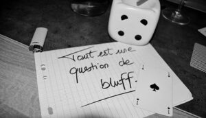 gambling die, ace of spades, and a note in French -- Tout est une question de bluff